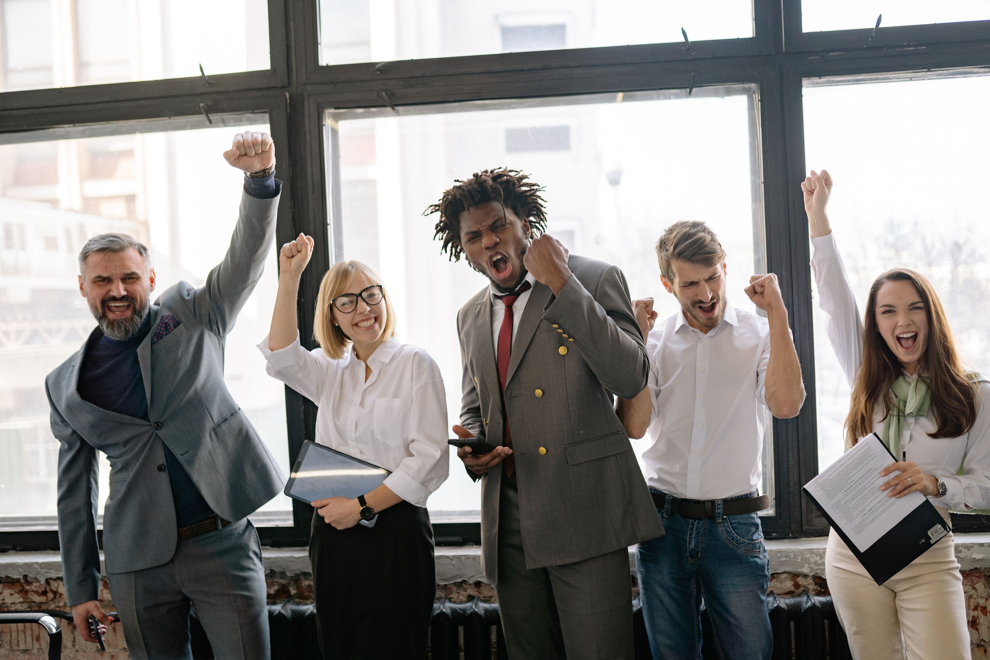 A diverse business team celebrating together in an office